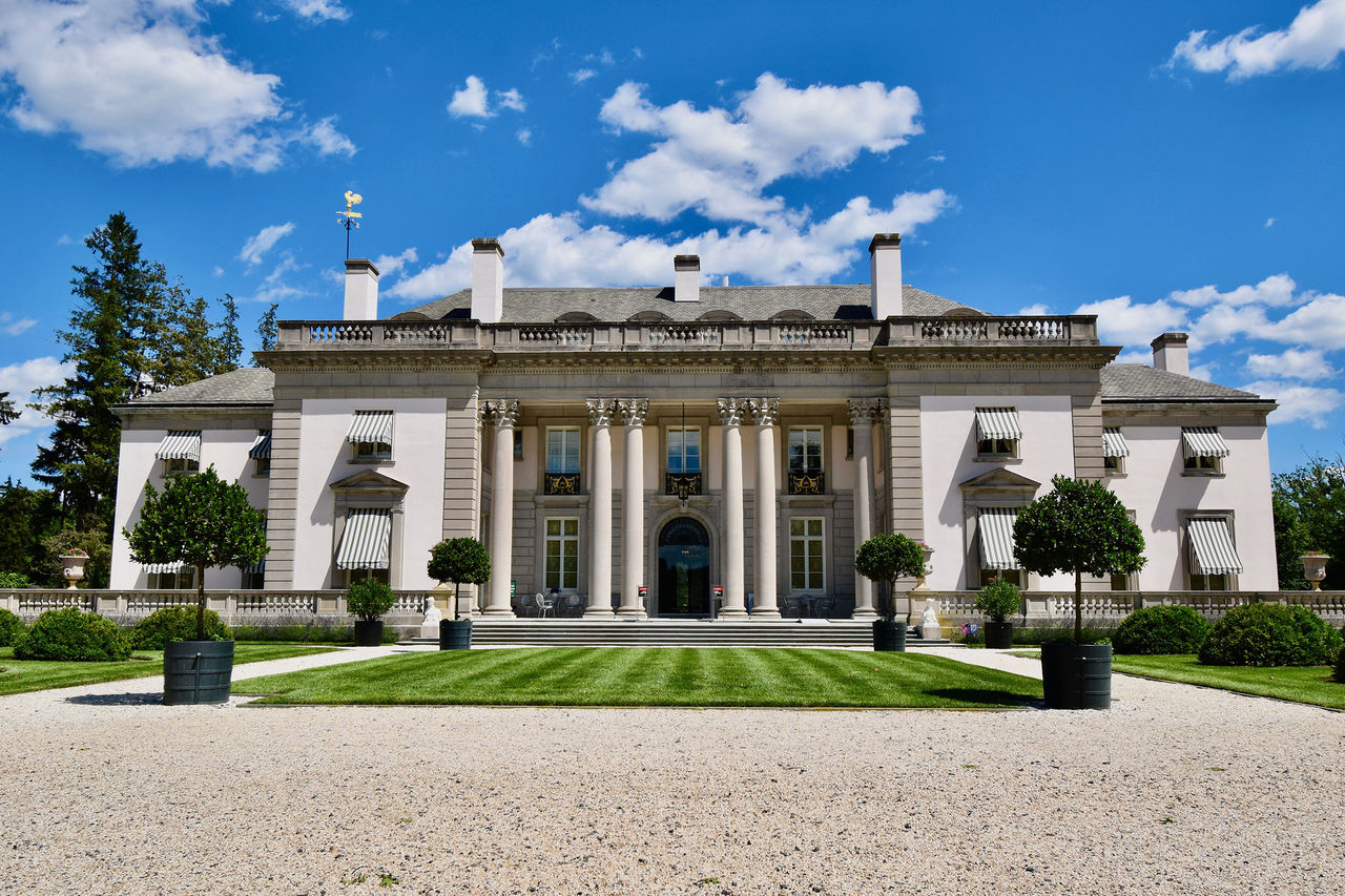 An exterior view of the mansion building on a sunny day.