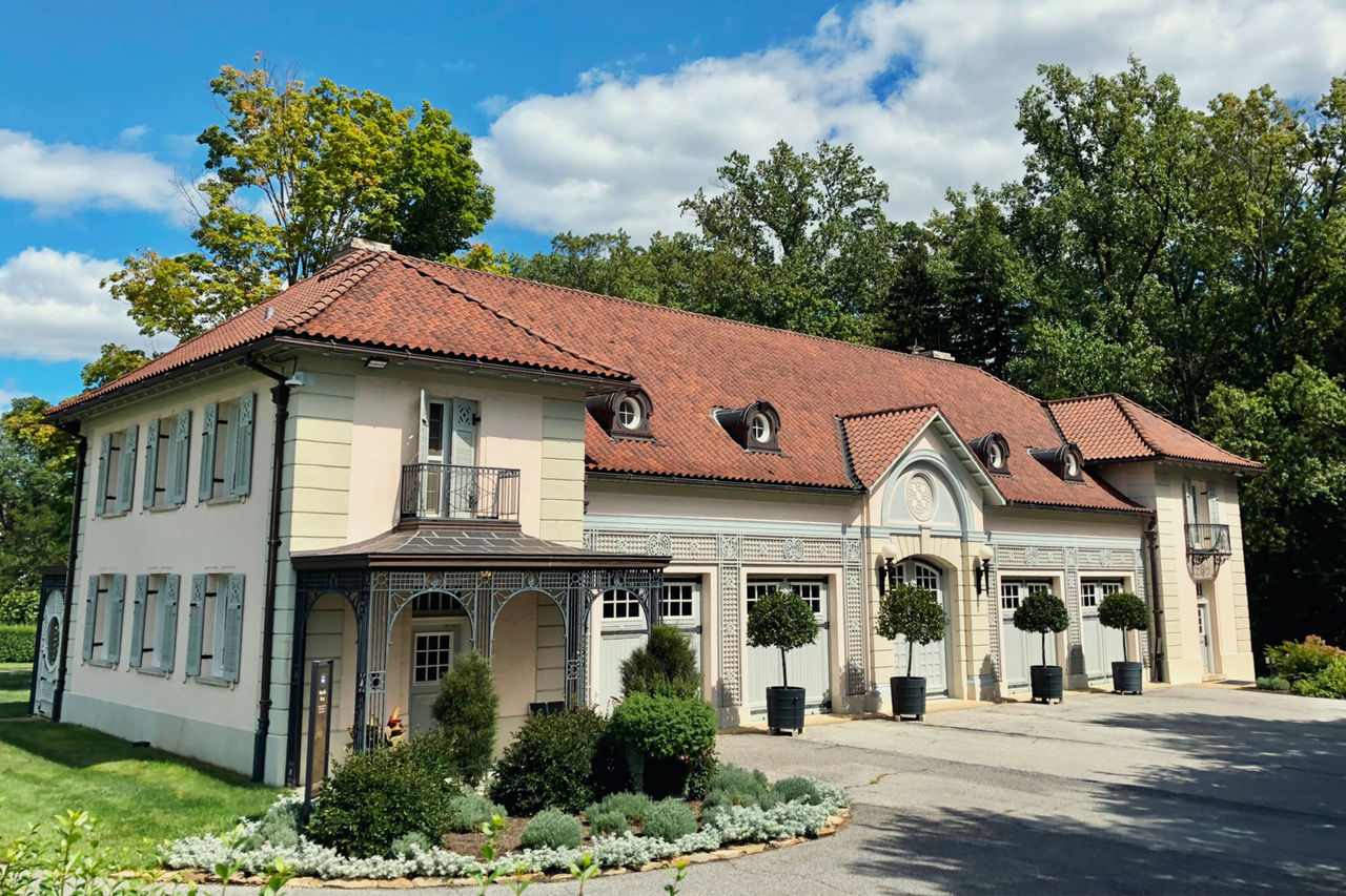 The large exterior of the Chauffeur's Garage building at Nemours Estate on a sunny day.