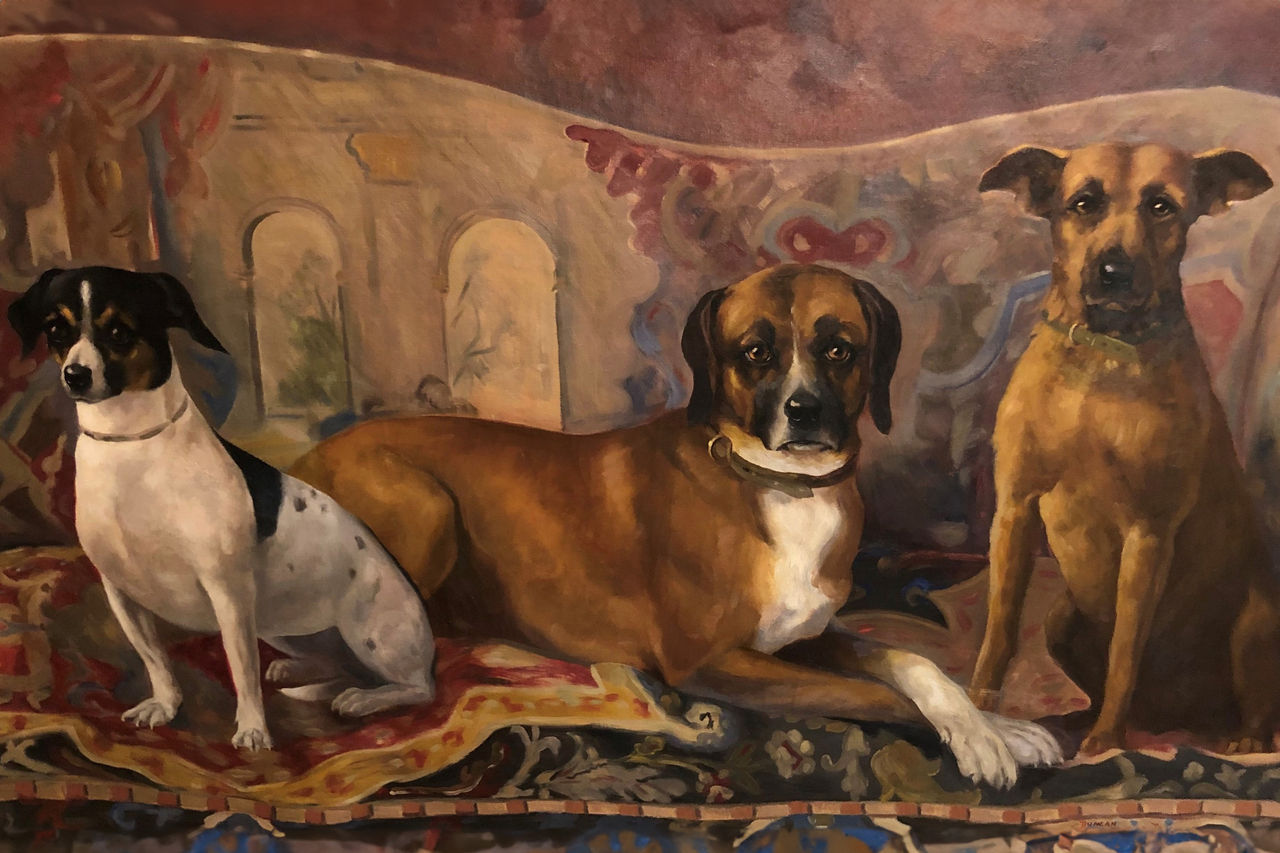 Three dogs posing in front of an abstract background in a mural at the Nemours Estate. 