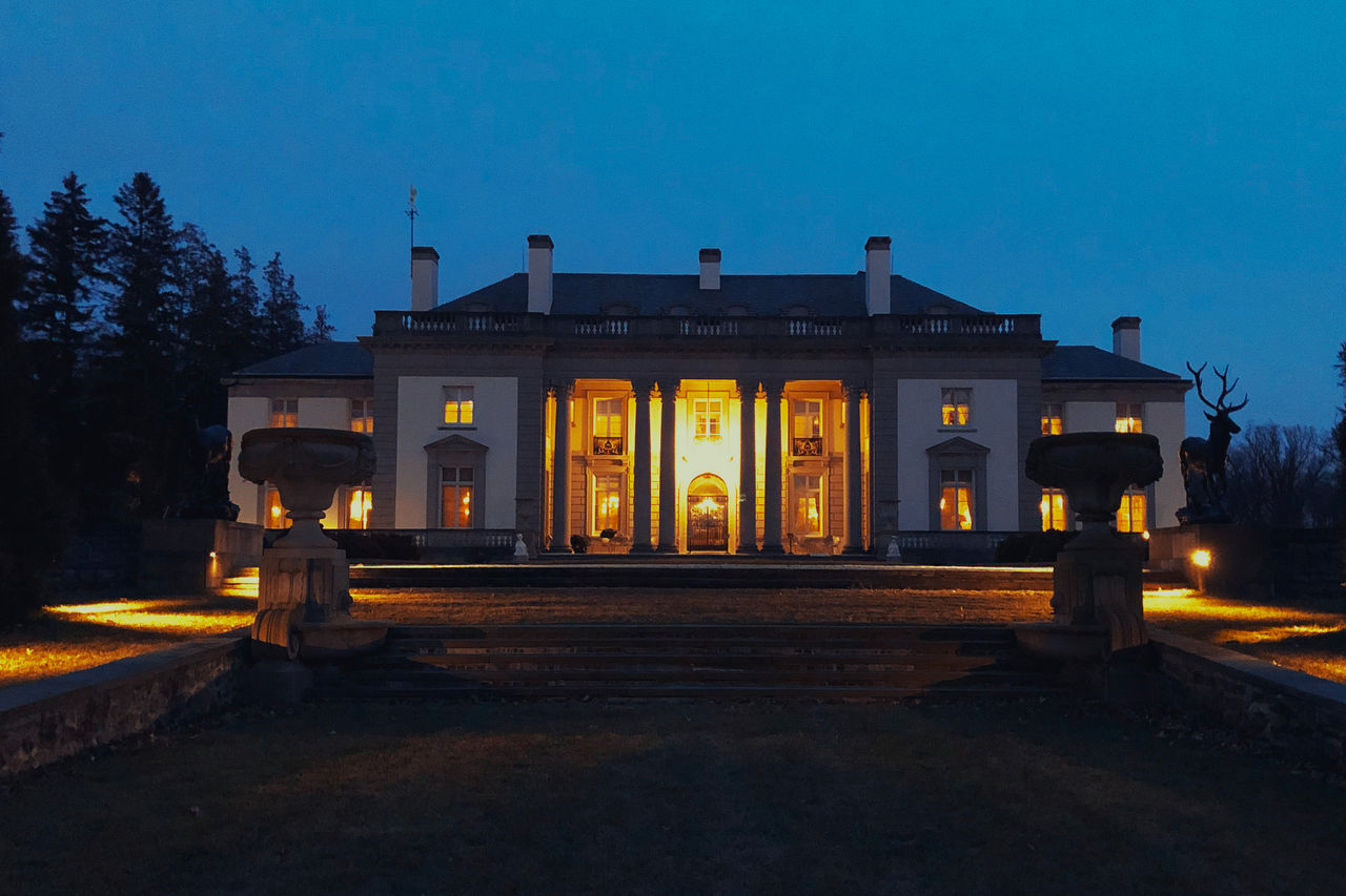 Night time photograph of the Nemours Estate mansion..